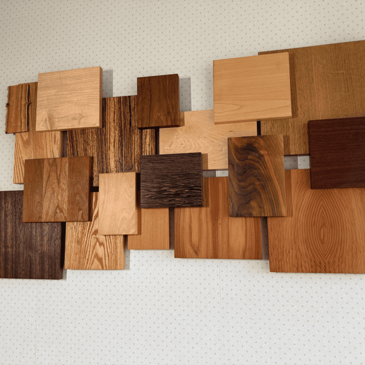 Wooden sample boards in various shades and textures, showcasing craftsmanship and material variety for custom furniture and cabinetry projects.