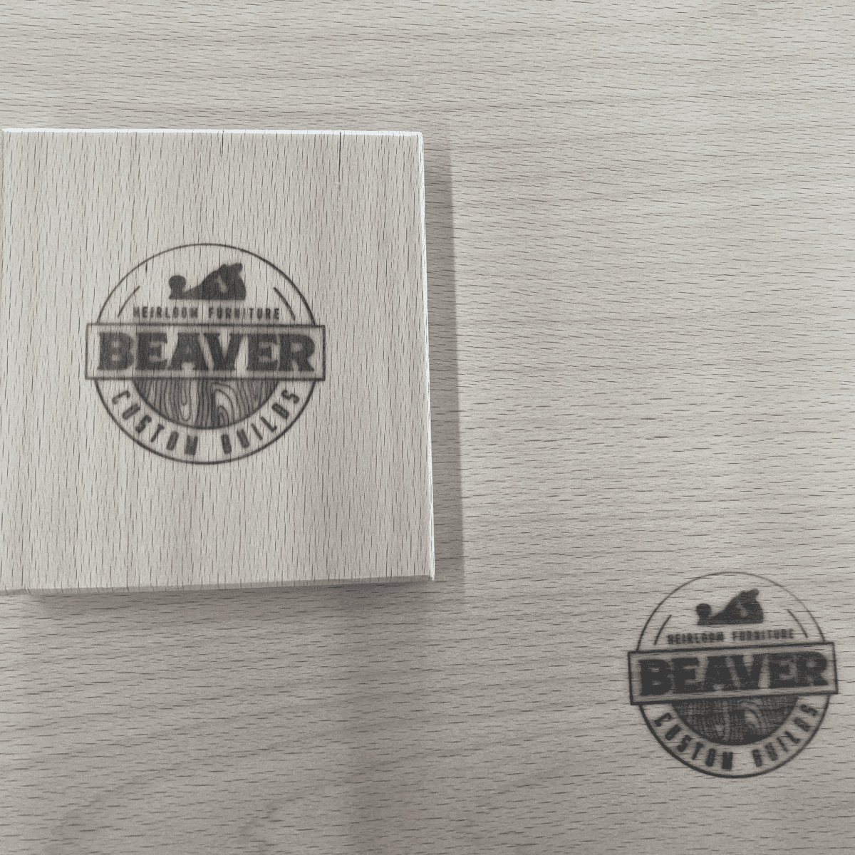 Beaver Custom Builds logo on wood surface, showcasing craftsmanship and quality in custom furniture and woodworking.