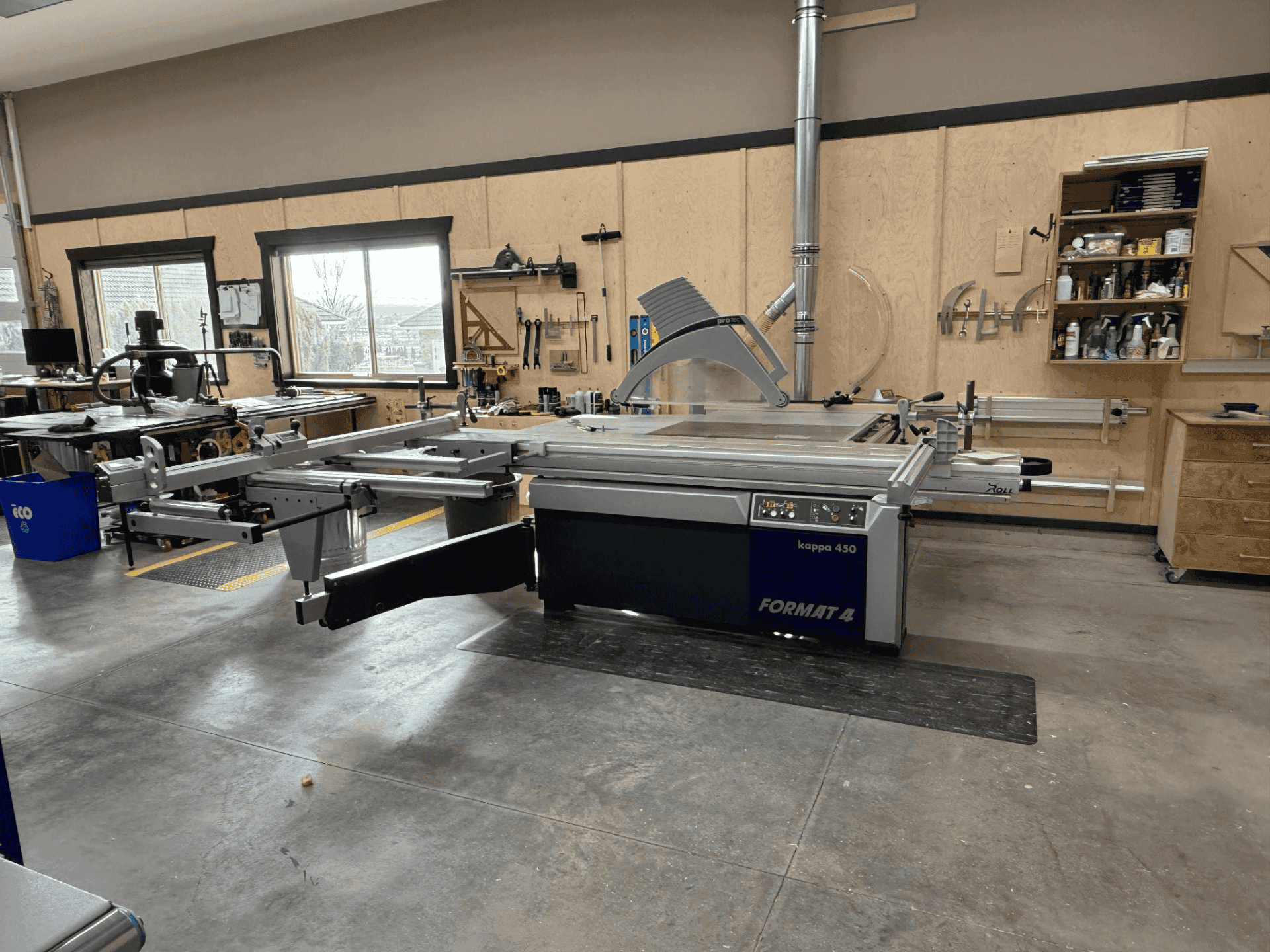 High-precision European woodworking machinery in Beaver Custom Builds workshop, showcasing craftsmanship and design process for custom furniture.