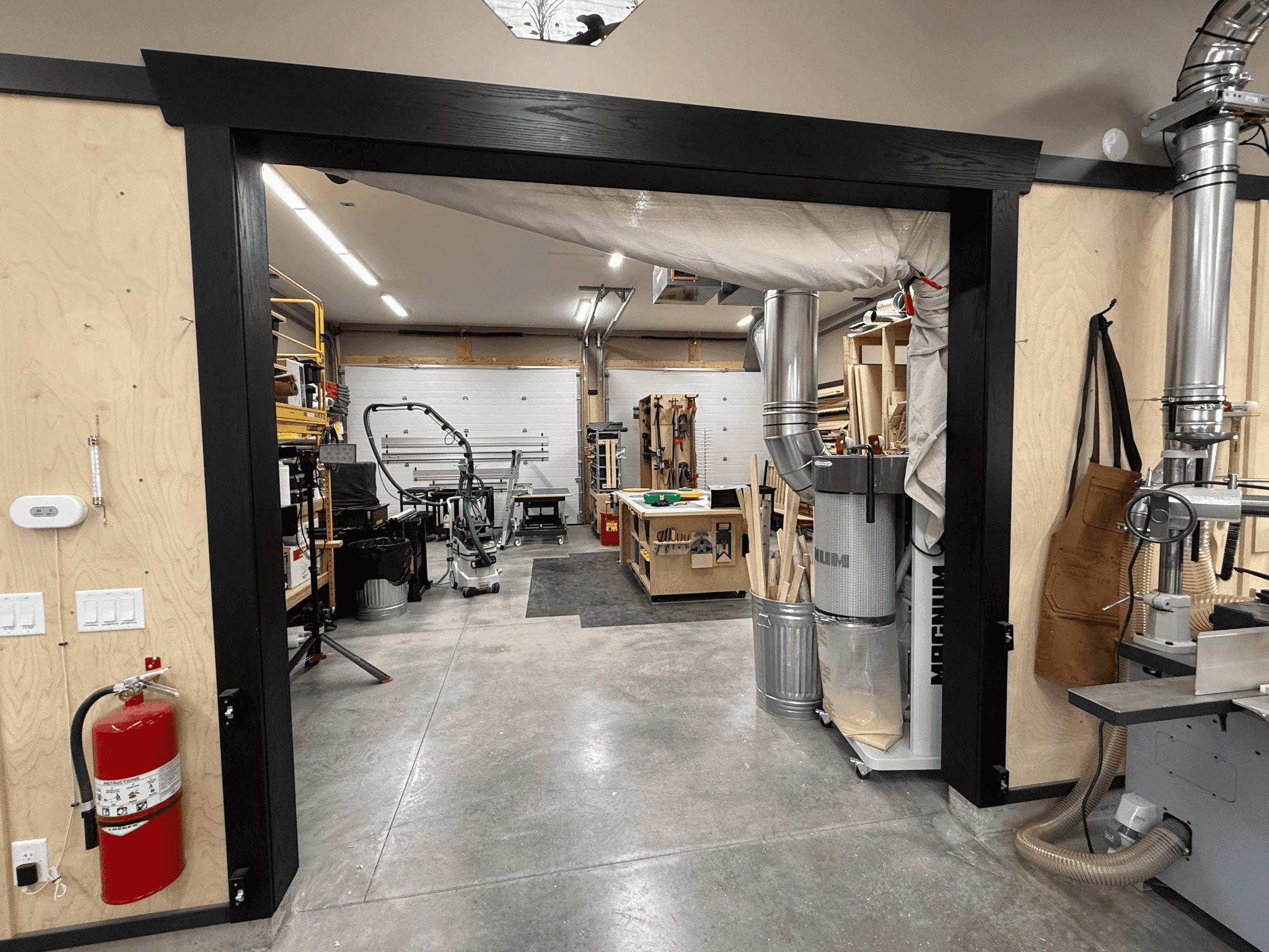 Workshop interior featuring high-precision woodworking tools, organized workspace, and safety equipment, reflecting Beaver Custom Builds' commitment to quality craftsmanship and meticulous attention to detail.